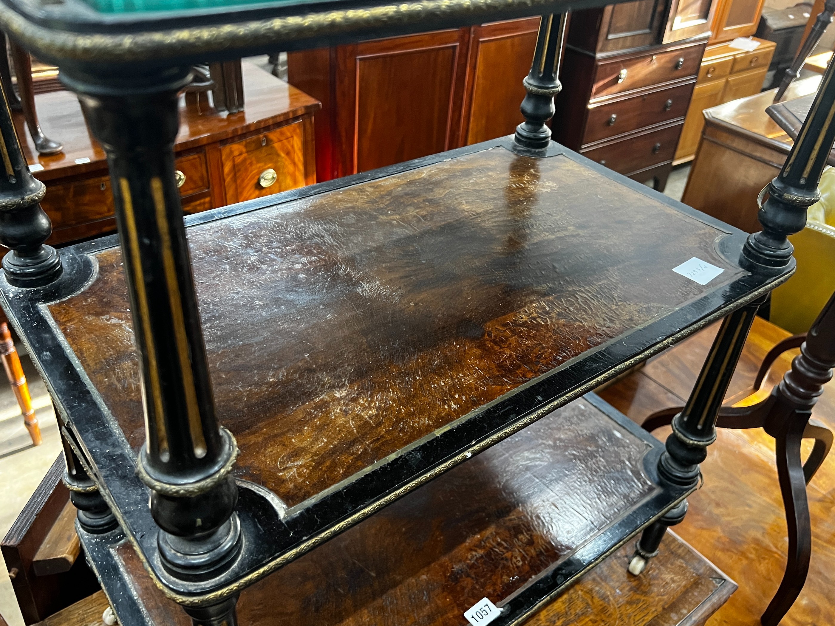 A late Victorian ebonised and amboyna three tier whatnot, width 66cm, depth 39cm, height 81cm